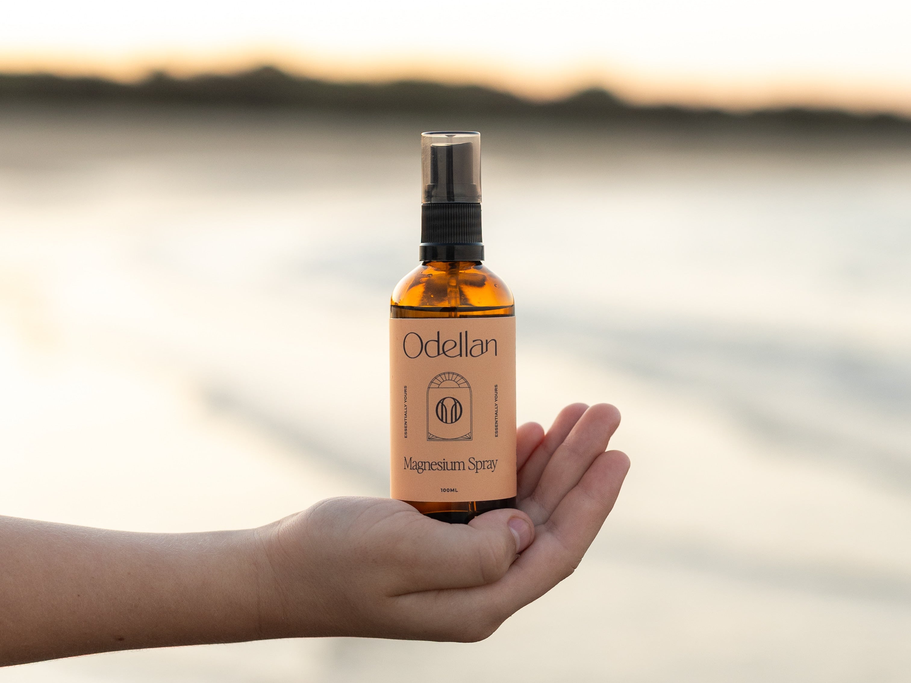 Odellan's 100mL Magnesium Oil Spray - sitting on a hand