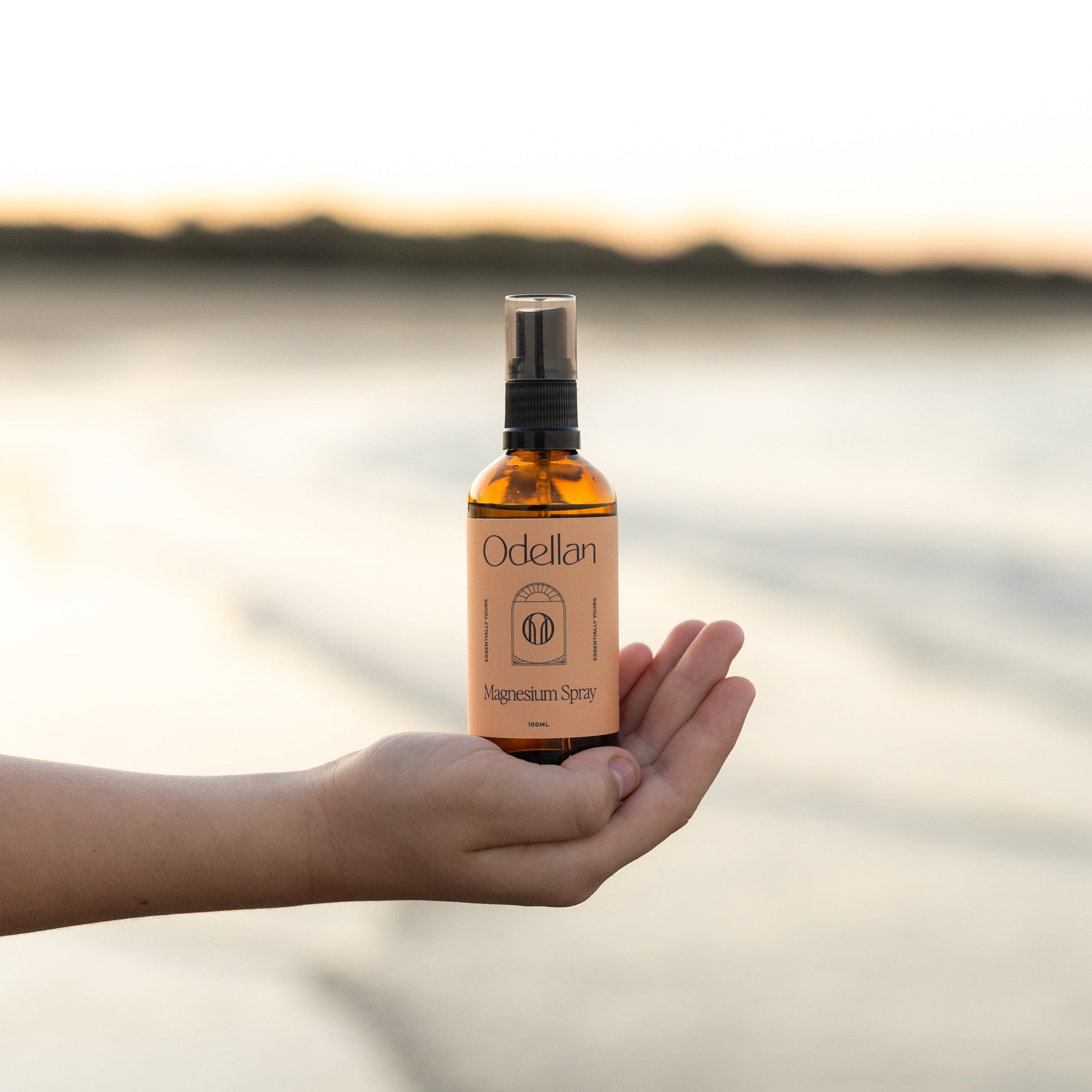 Odellan's 100mL Magnesium Oil Spray - sitting on a hand