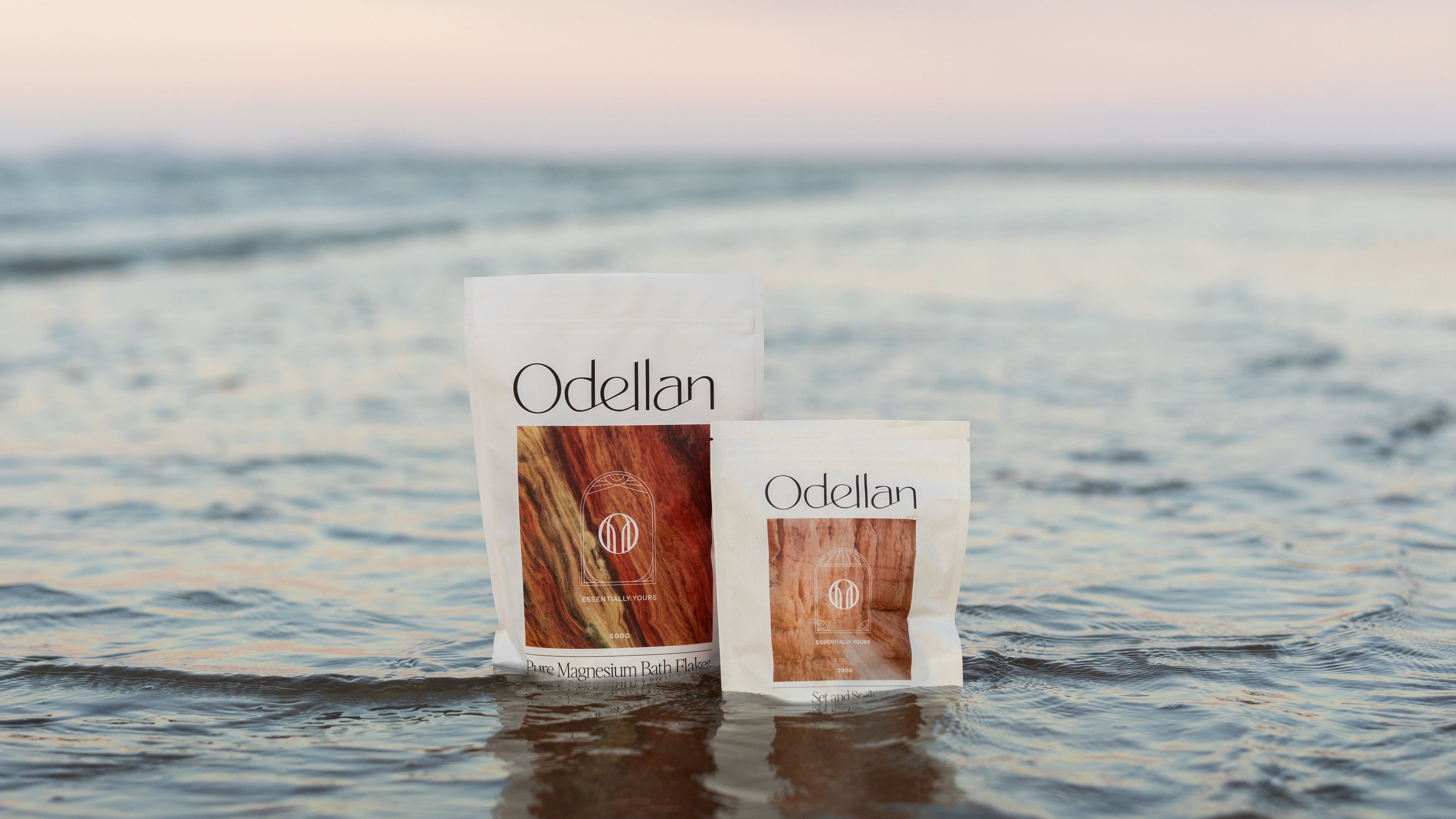 Odellan's Pure Magnesium Bath Flakes and Set & Soak sitting in the ocean